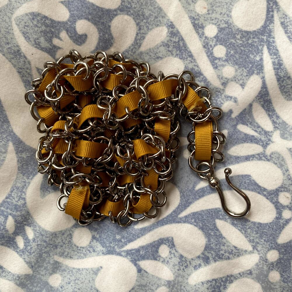 Silver chain belt with yellow ribbon weaved through size Medium